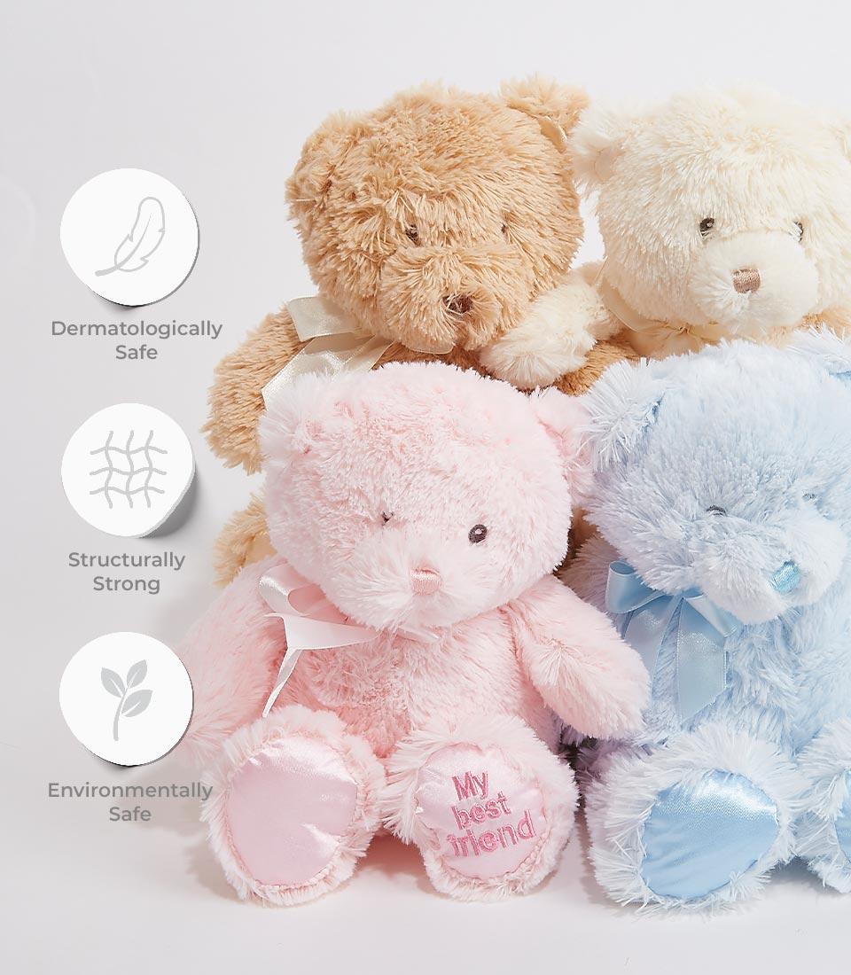 A collection of four plush teddy bears in different pastel colors, The bears feature embroidered 