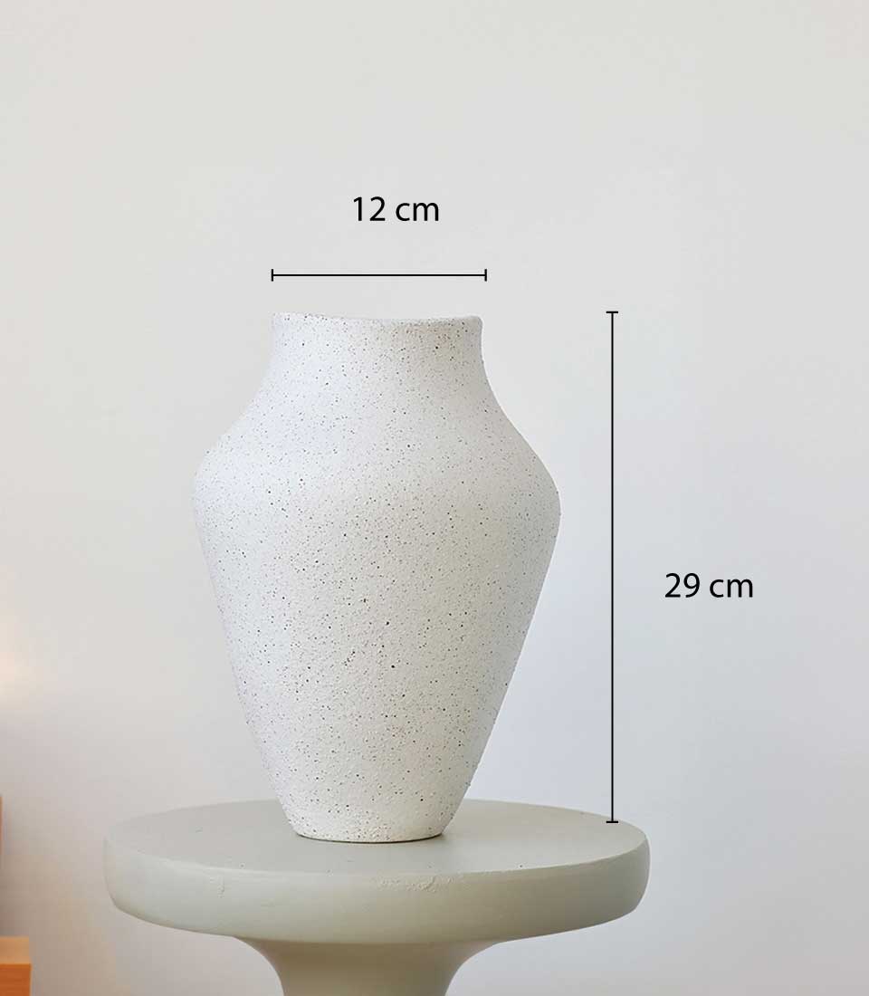 A modern, 12 cm x 29 cm white vase with a textured finish.