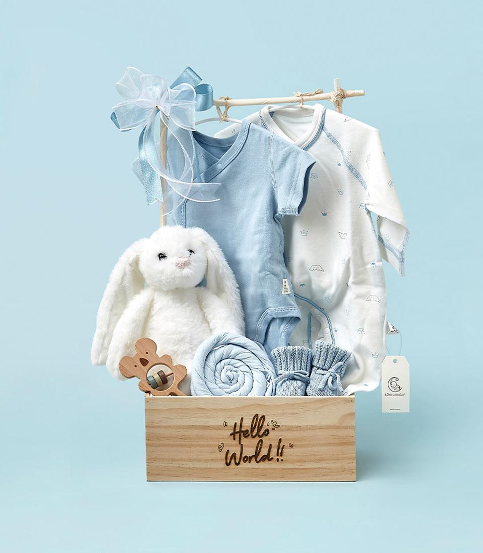 A charming collection of newborn essentials is housed in a wooden box labeled 