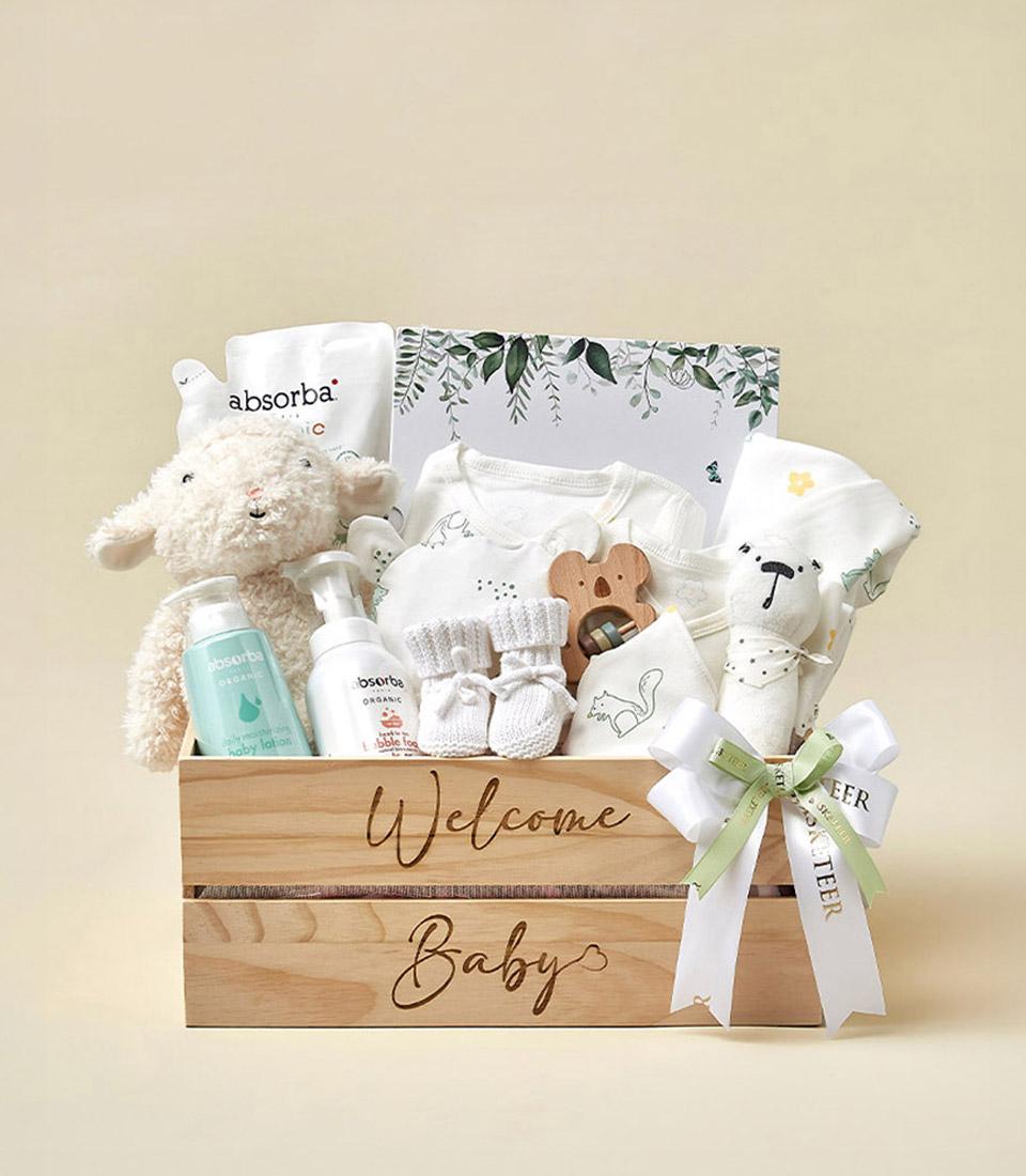 A charming collection of newborn essentials awaits in this wooden box engraved with 