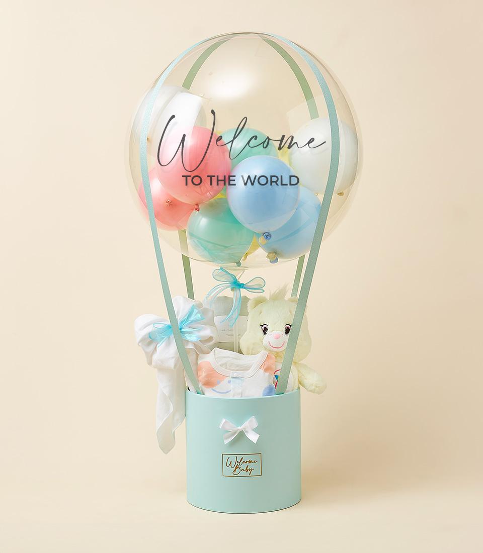 A baby gift arrangement featuring a balloon with 