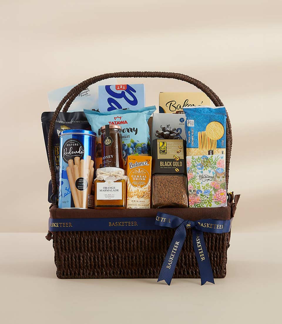 A luxurious gift basket filled with gourmet delicacies, including chocolate, biscuits, and coffee.