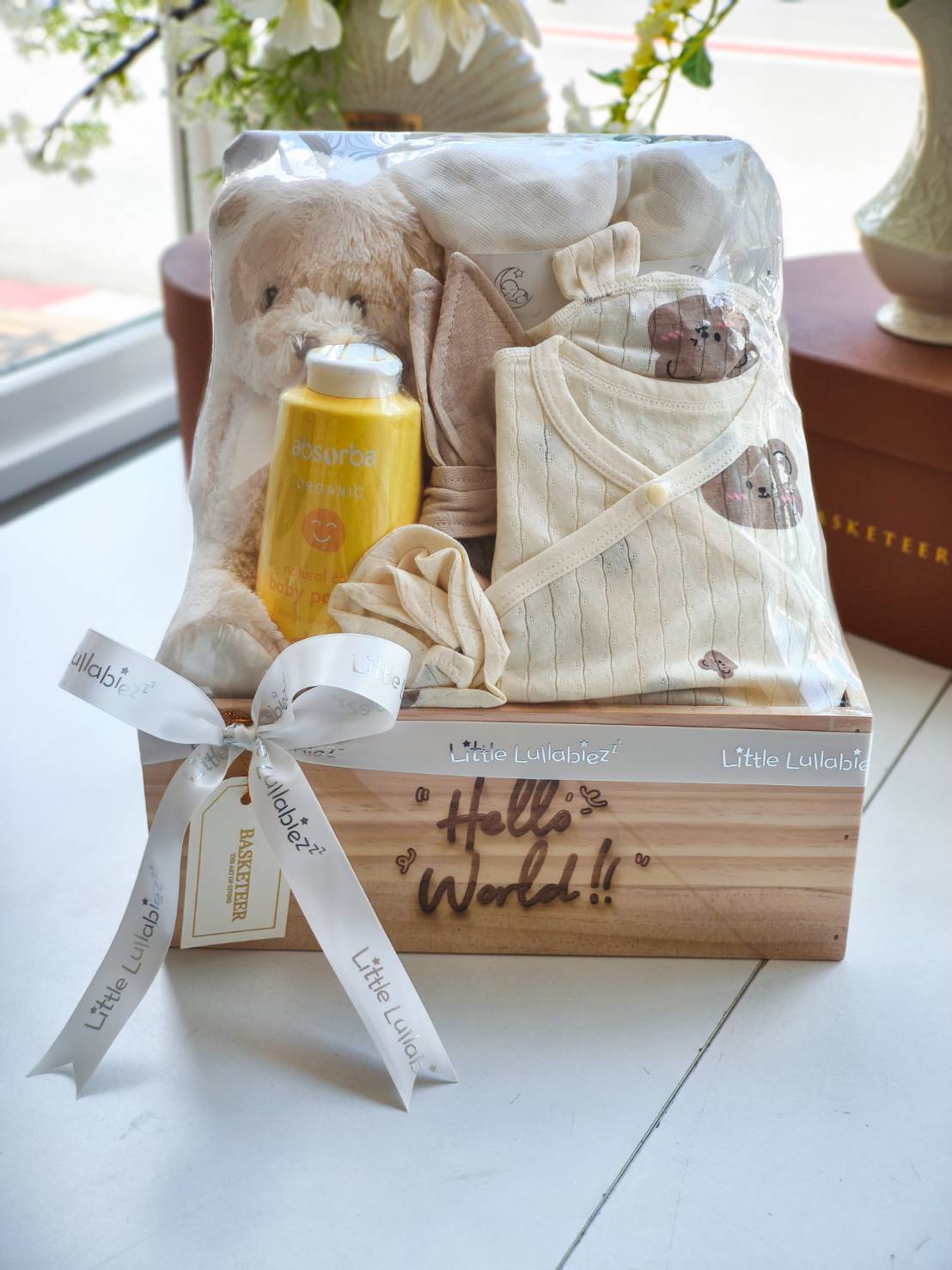 Celebrate a newborn’s arrival with this adorable baby welcome gift set. Featuring organic baby wear, soft blankets, a cuddly teddy bear, and natural baby care products, this gift is perfect for parents and little ones, beautifully packed in a wooden box with ribbon.