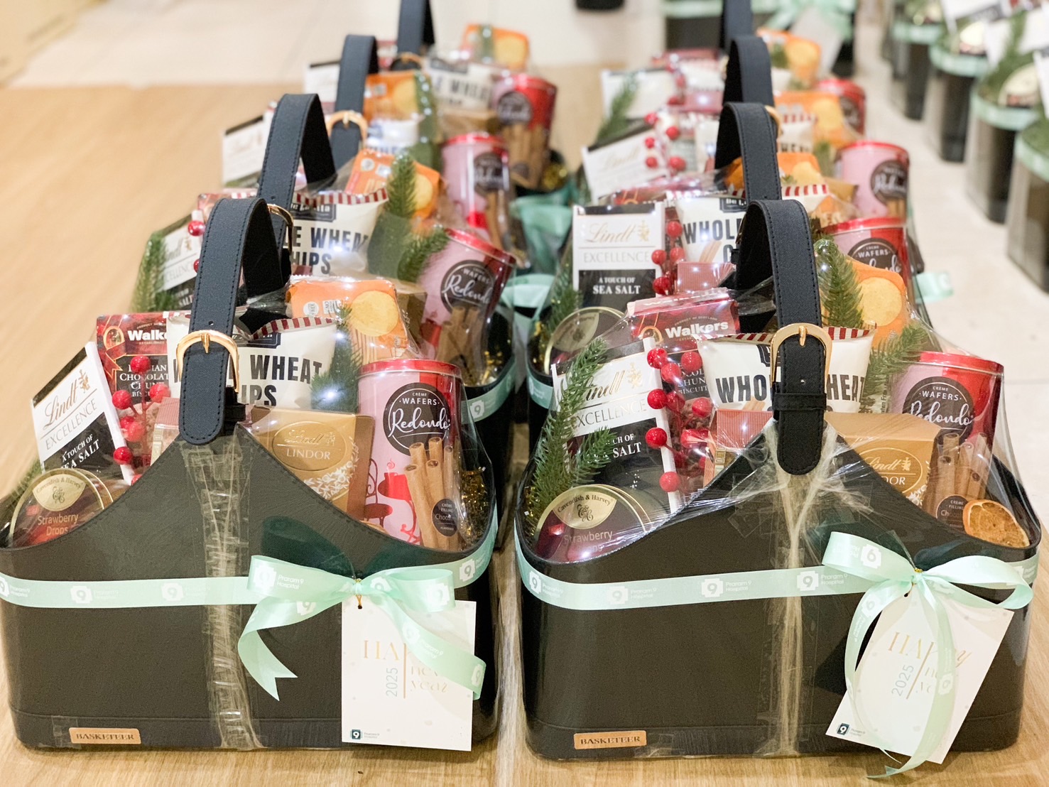 A black basket filled with a variety of gourmet food items.