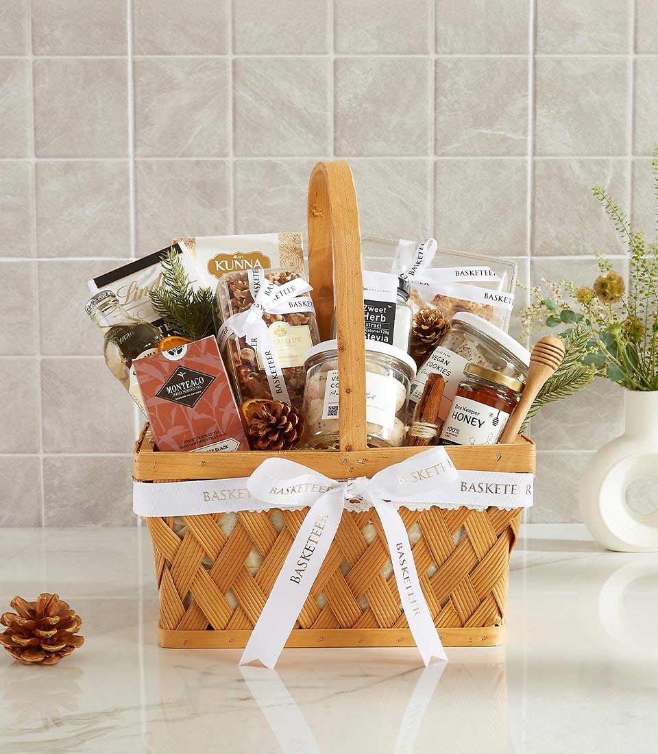 A wicker basket filled with a variety of gourmet food items.