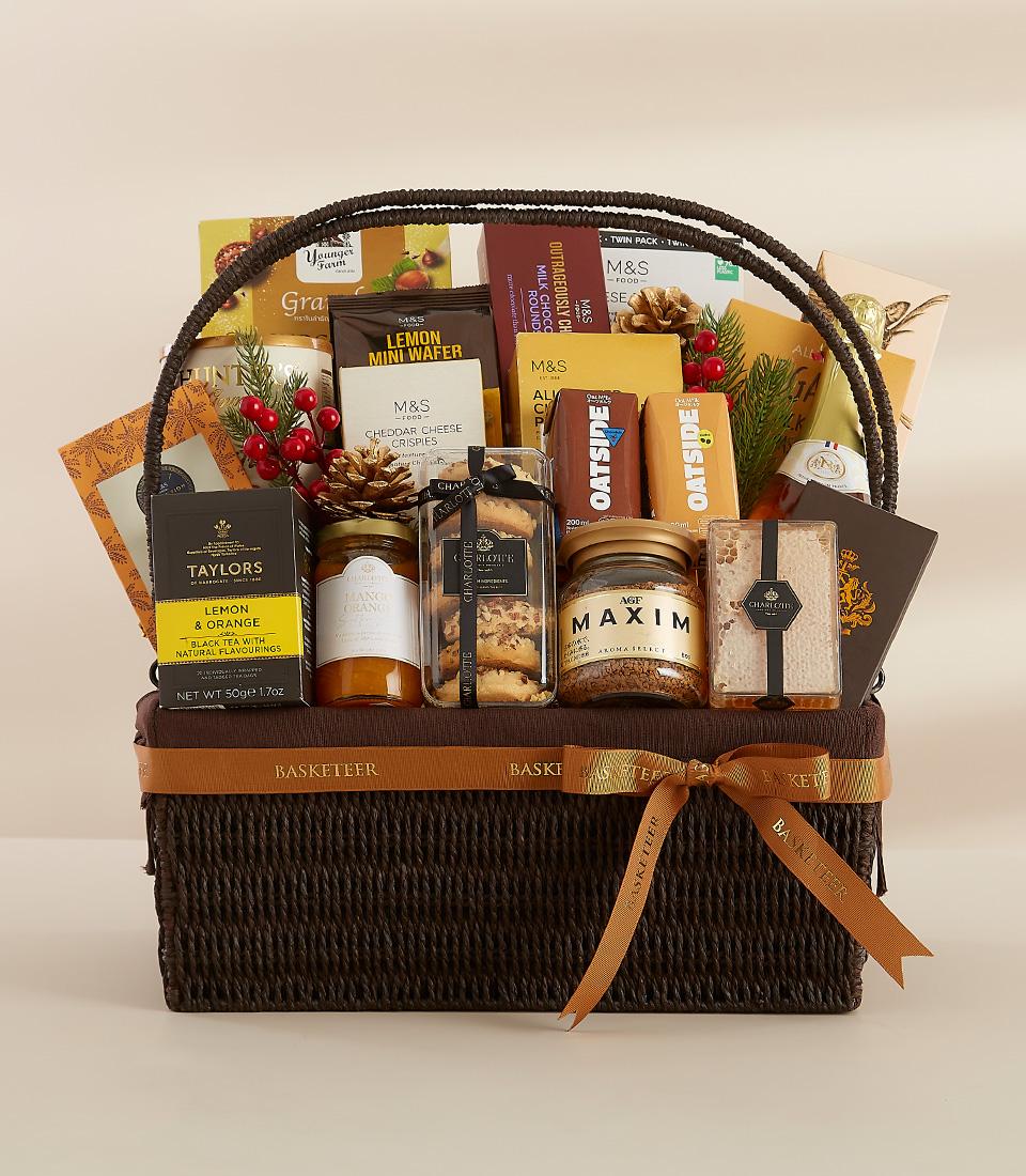 A luxurious gift basket filled with gourmet delicacies, including chocolate, biscuits, and coffee.
