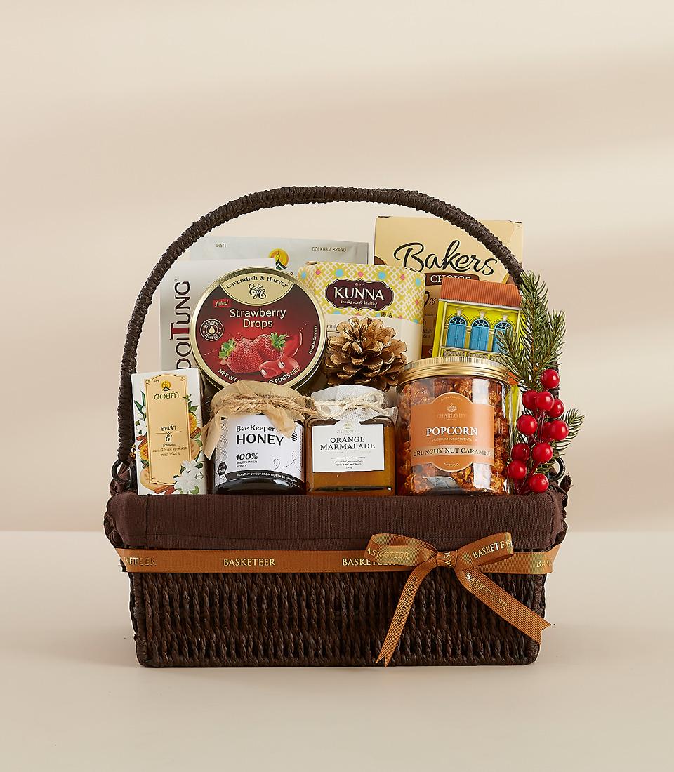 A festive gift basket featuring a selection of sweet and savory treats, perfect for sharing with loved ones.