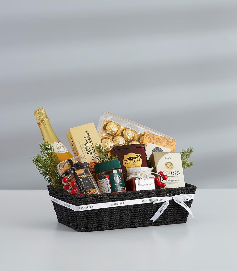 A festive gift basket featuring a selection of sweet and savory treats, perfect for sharing with loved ones.