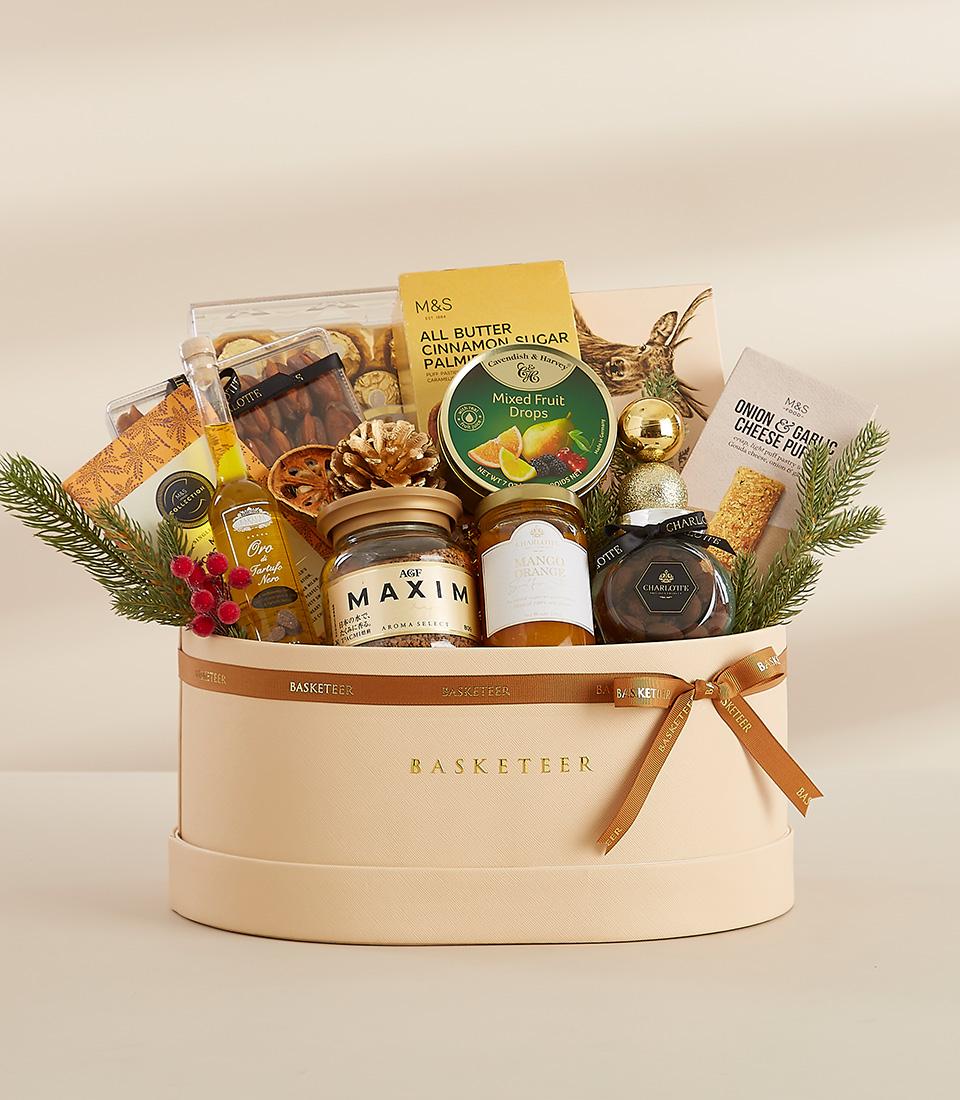 A luxurious gift box filled with gourmet delicacies, including chocolate, biscuits, and marmalade.