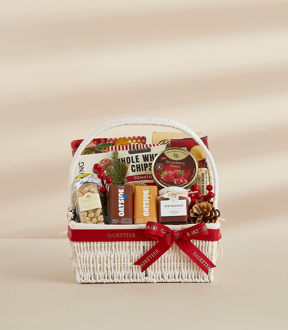 A charming wicker basket filled with delicious snacks and drinks, ideal for the holiday season.