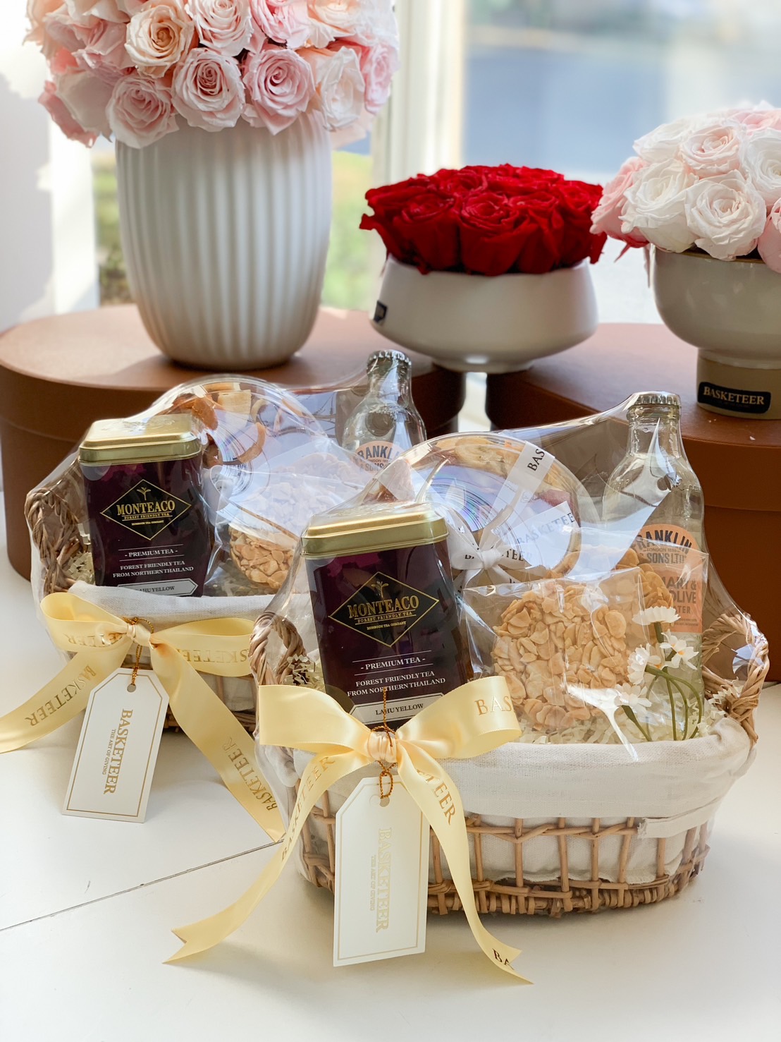 A premium tea and gourmet snack gift set, beautifully arranged in an elegant woven basket with a golden ribbon. Features premium Monteaco tea, gourmet cookies, artisanal drinks, and sweet delicacies—a perfect gift for tea lovers, corporate gifting, and special occasions.