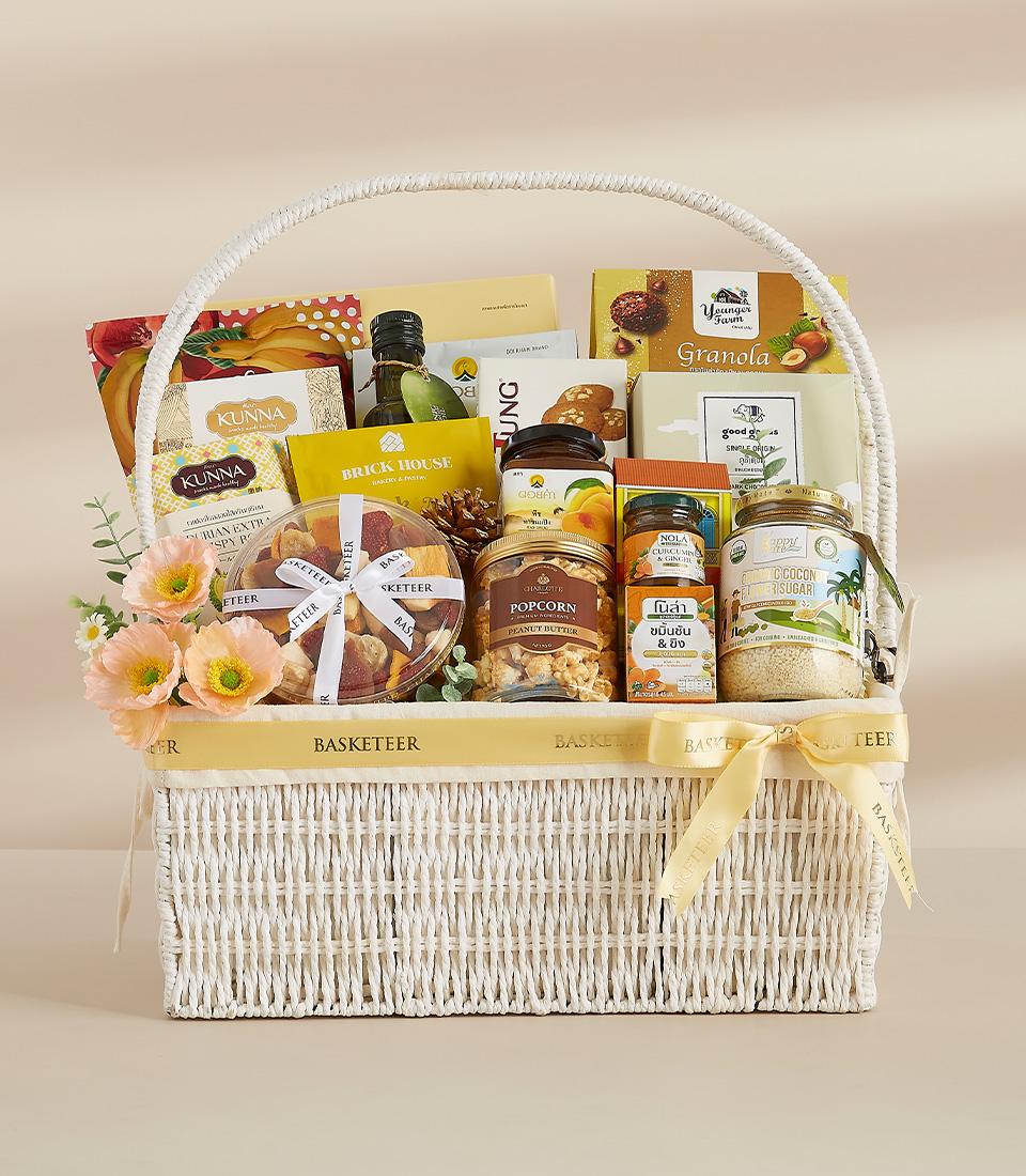 A festive gift basket featuring a variety of Thai-inspired treats, perfect for sharing with loved ones.