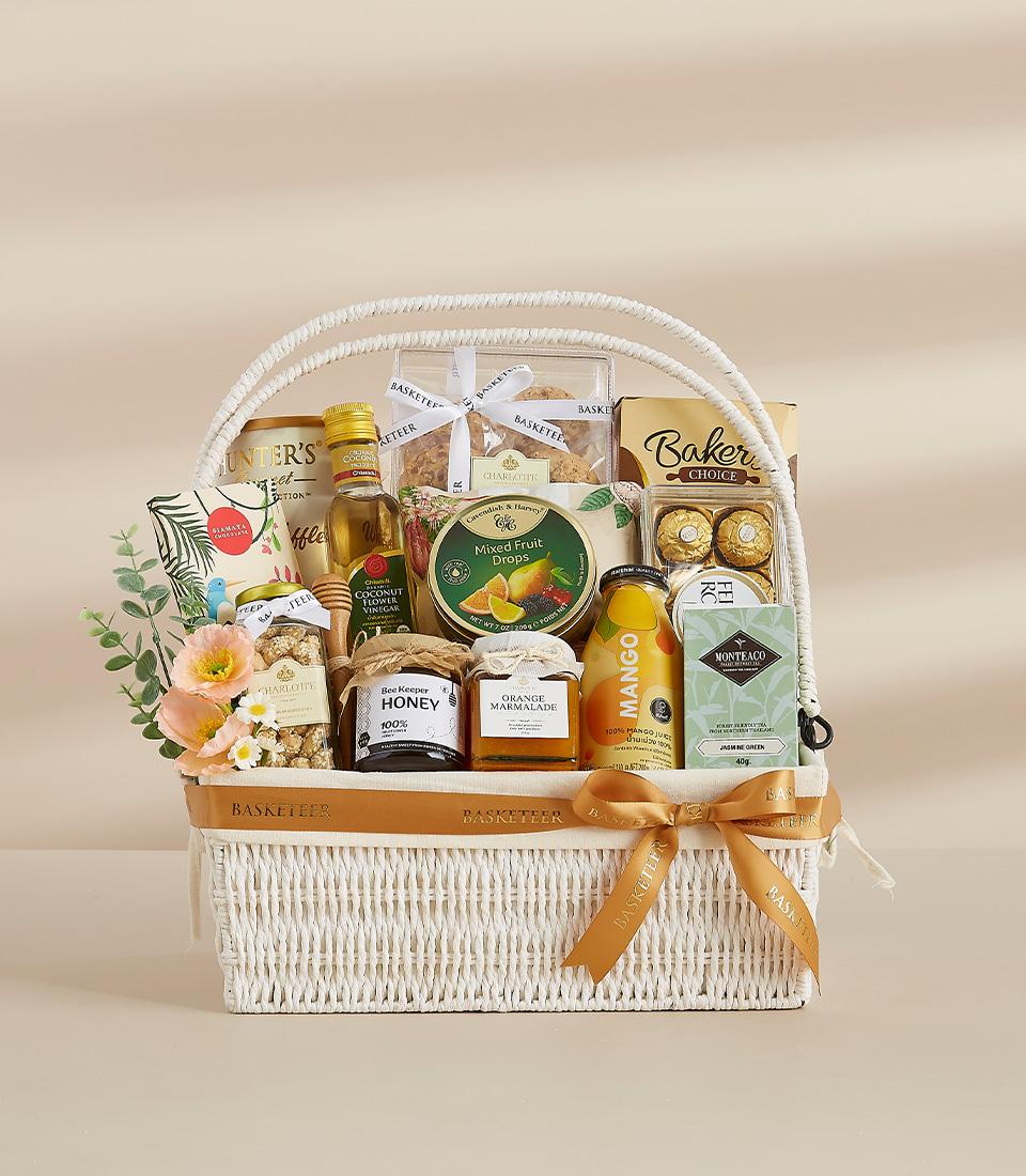 A festive gift basket featuring a selection of sweet and savory treats, perfect for sharing with loved ones.