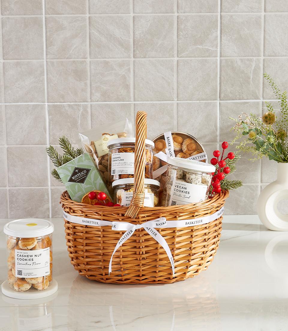 Classic gourmet gift basket with assorted cookies, holiday decorations, and ribbon.