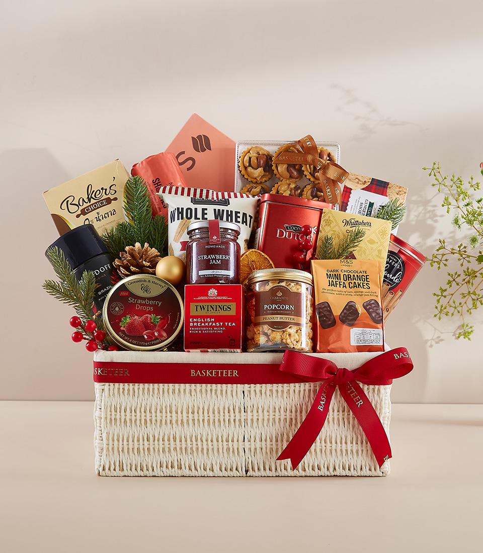 A white wicker basket filled with a variety of gourmet food items.