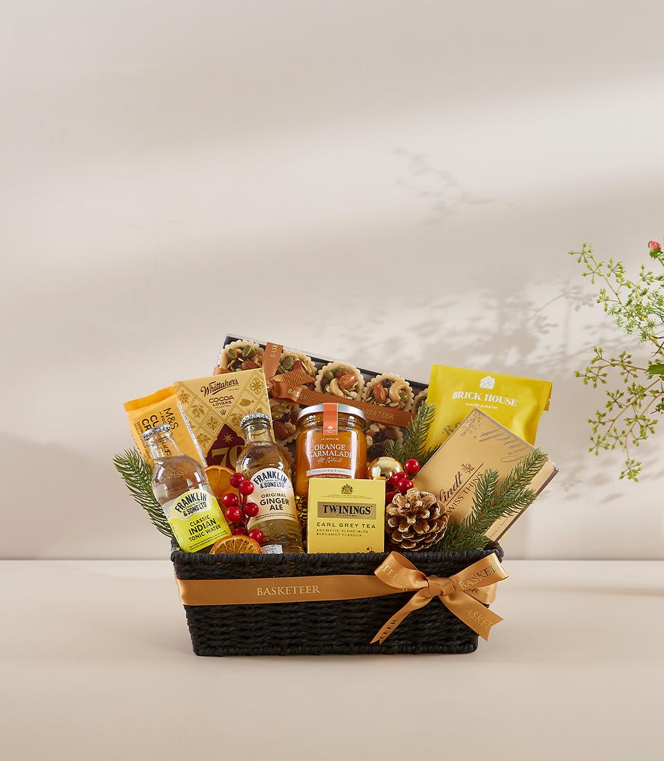 A black basket filled with a variety of gourmet food items.