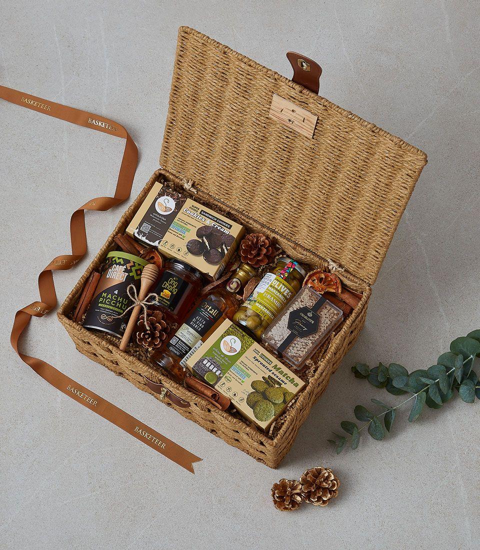 A gift picnic basket with assorted snacks and beverages.
