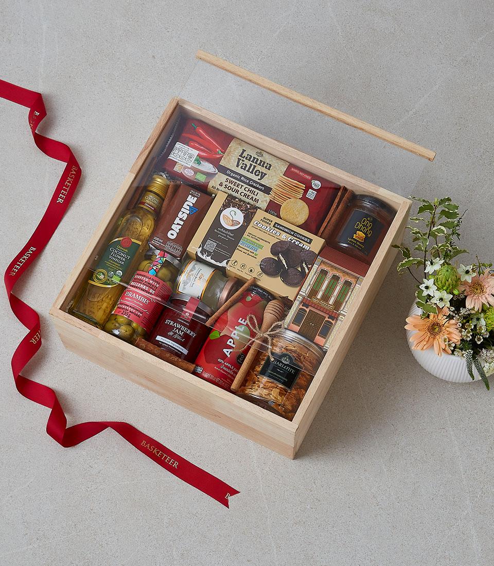 A collection of gourmet treats in a festive basket.