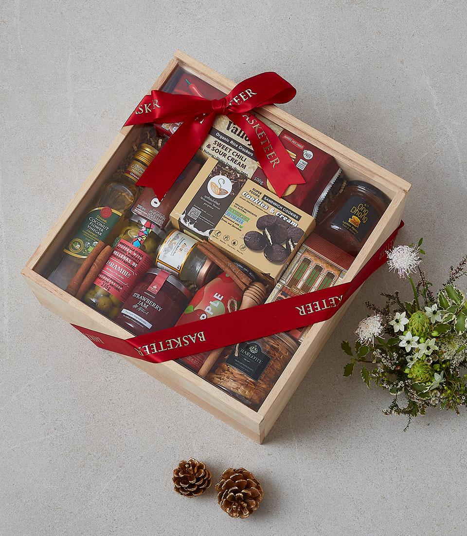 A collection of gourmet treats in a festive basket.