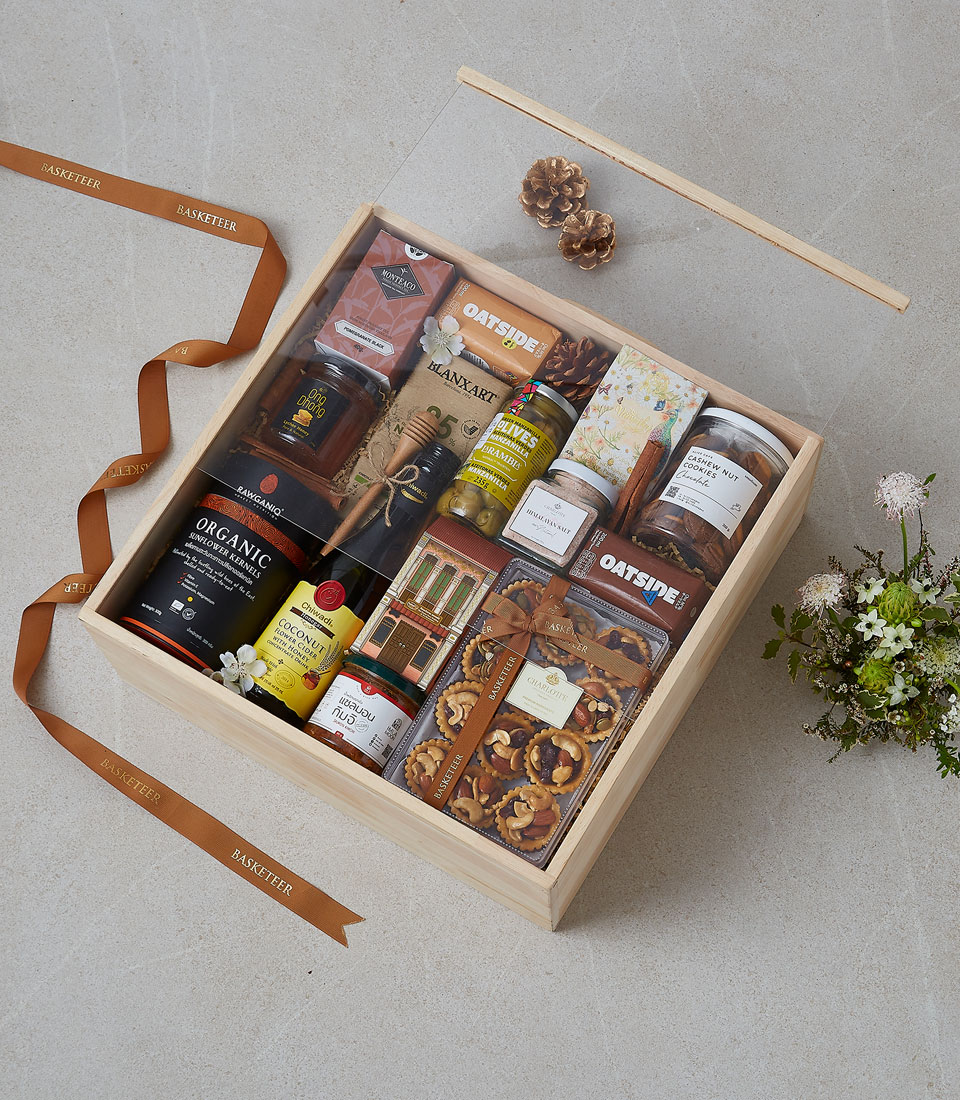 A collection of gourmet treats in a festive basket.