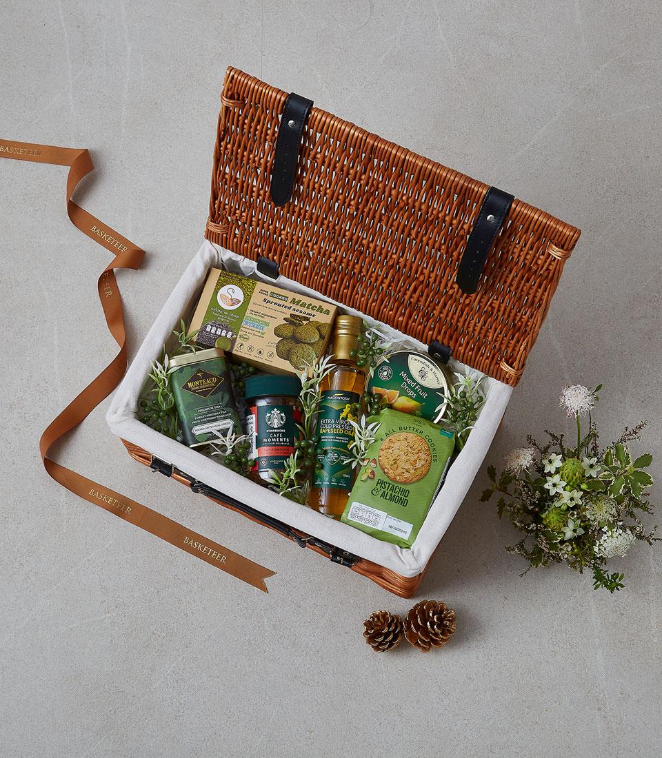 A collection of gourmet treats in a festive basket.