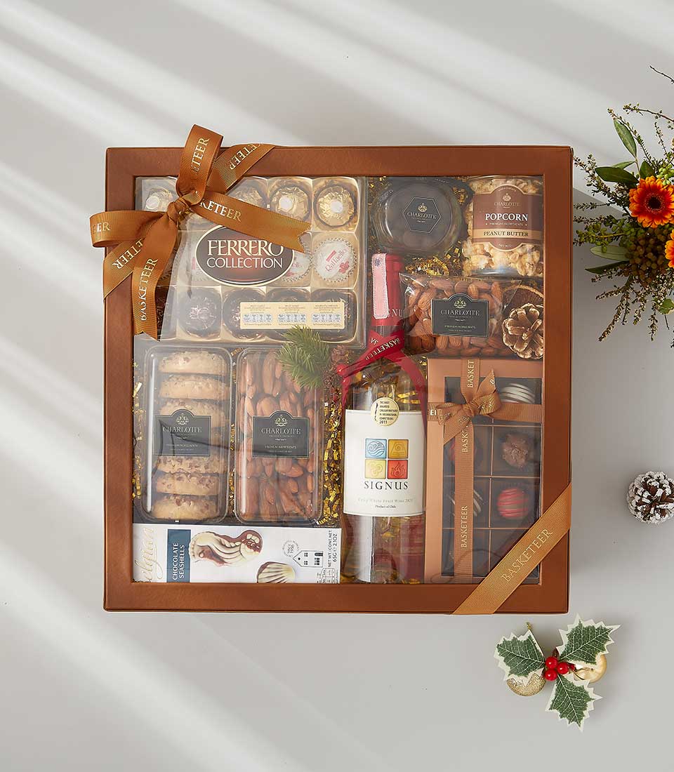 a festive gift box filled with a bottle of wine, decadent snacks, and holiday-scented candles.
