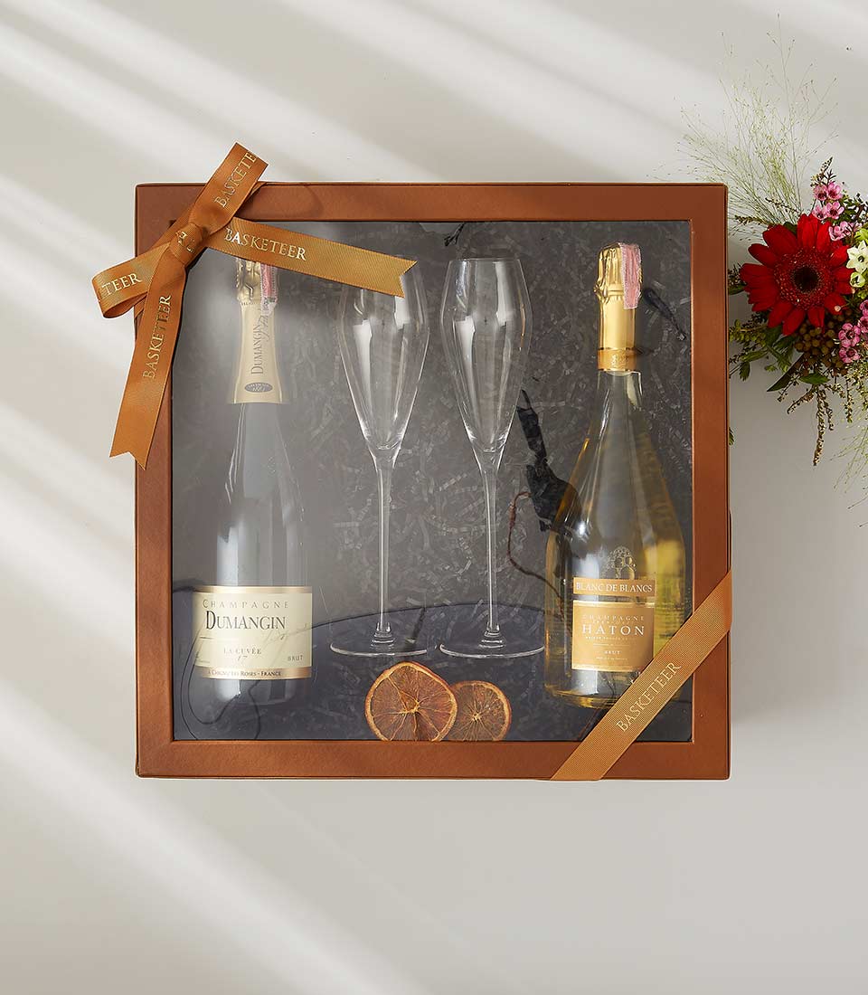 Luxury champagne gift box with Dumangin and Haton champagnes and two crystal flutes With a lid and beautifully tied with a bow.