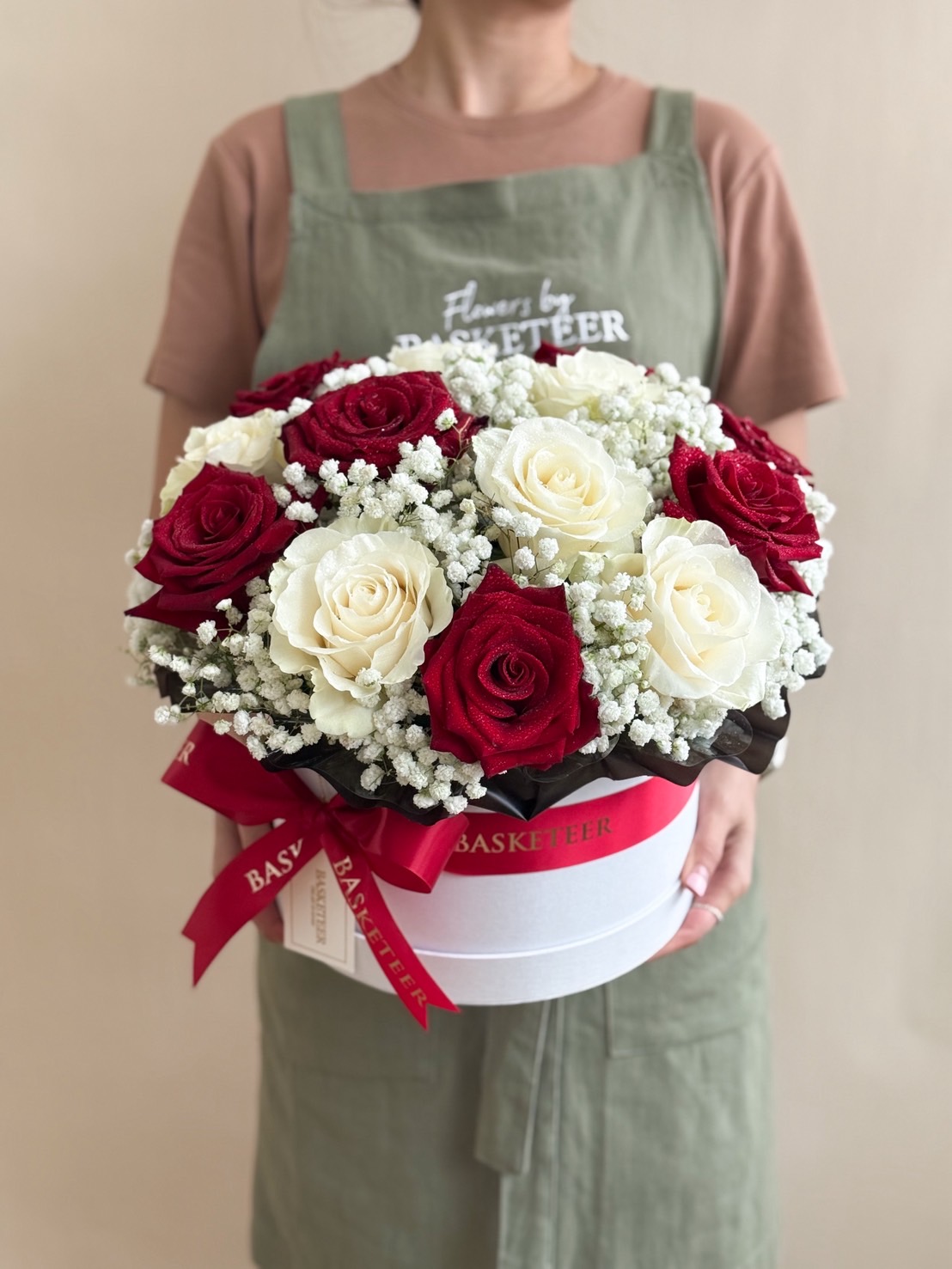 Elegant red and white rose arrangement with baby’s breath in round white box, luxury flower gift for love and anniversary.