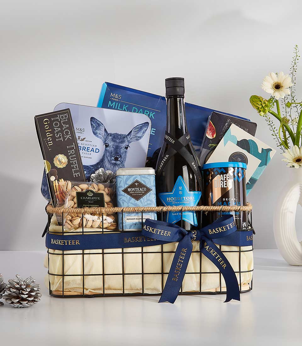 A stylish, navy blue gift basket filled with a variety of gourmet treats, including chocolate, crackers, nuts, and a bottle of wine.