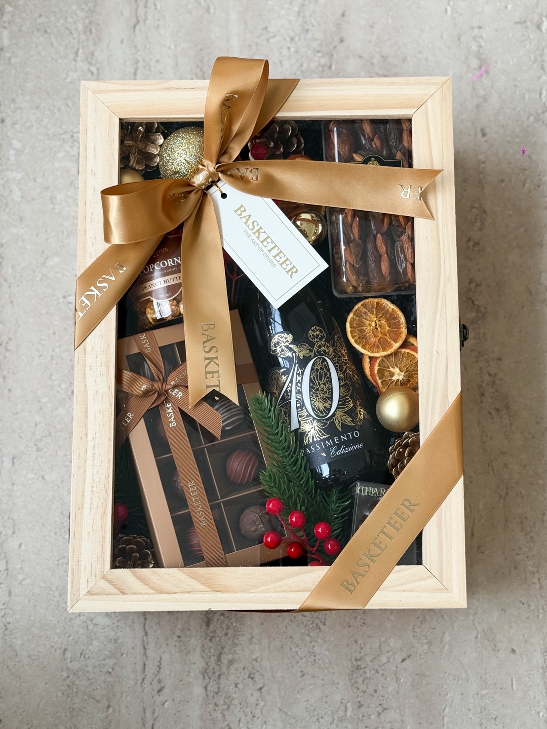A premium wooden gift hamper with 40 Appassimento wine, gourmet chocolates, and festive decor by Basketeer, luxury gifting Bangkok.
