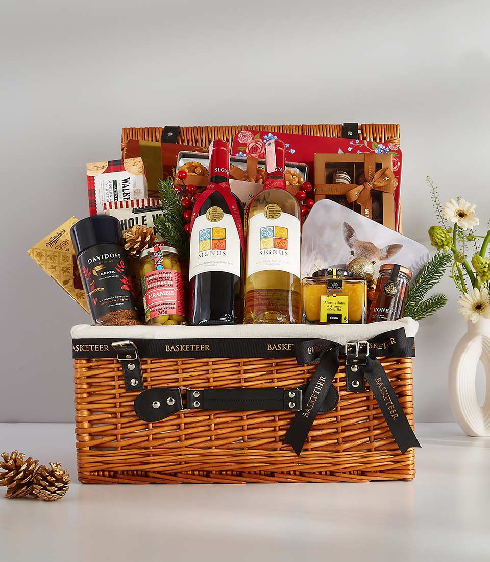 This elegant gift basket is filled with a variety of gourmet treats and personal items, including Davidoff coffee, fine wines, and various snacks.