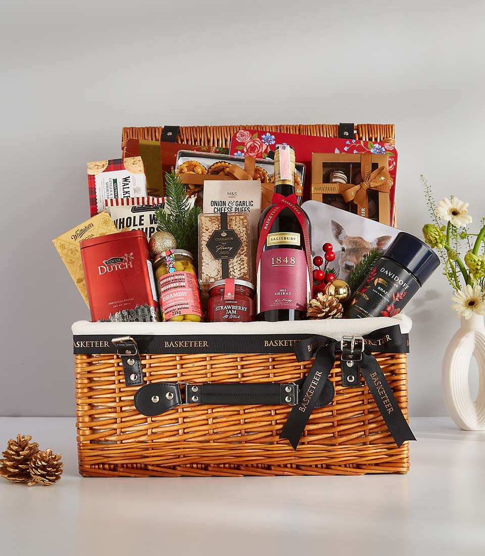 This elegant gift basket is filled with a variety of gourmet treats and personal items, including Davidoff coffee, fine wines, and various snacks.