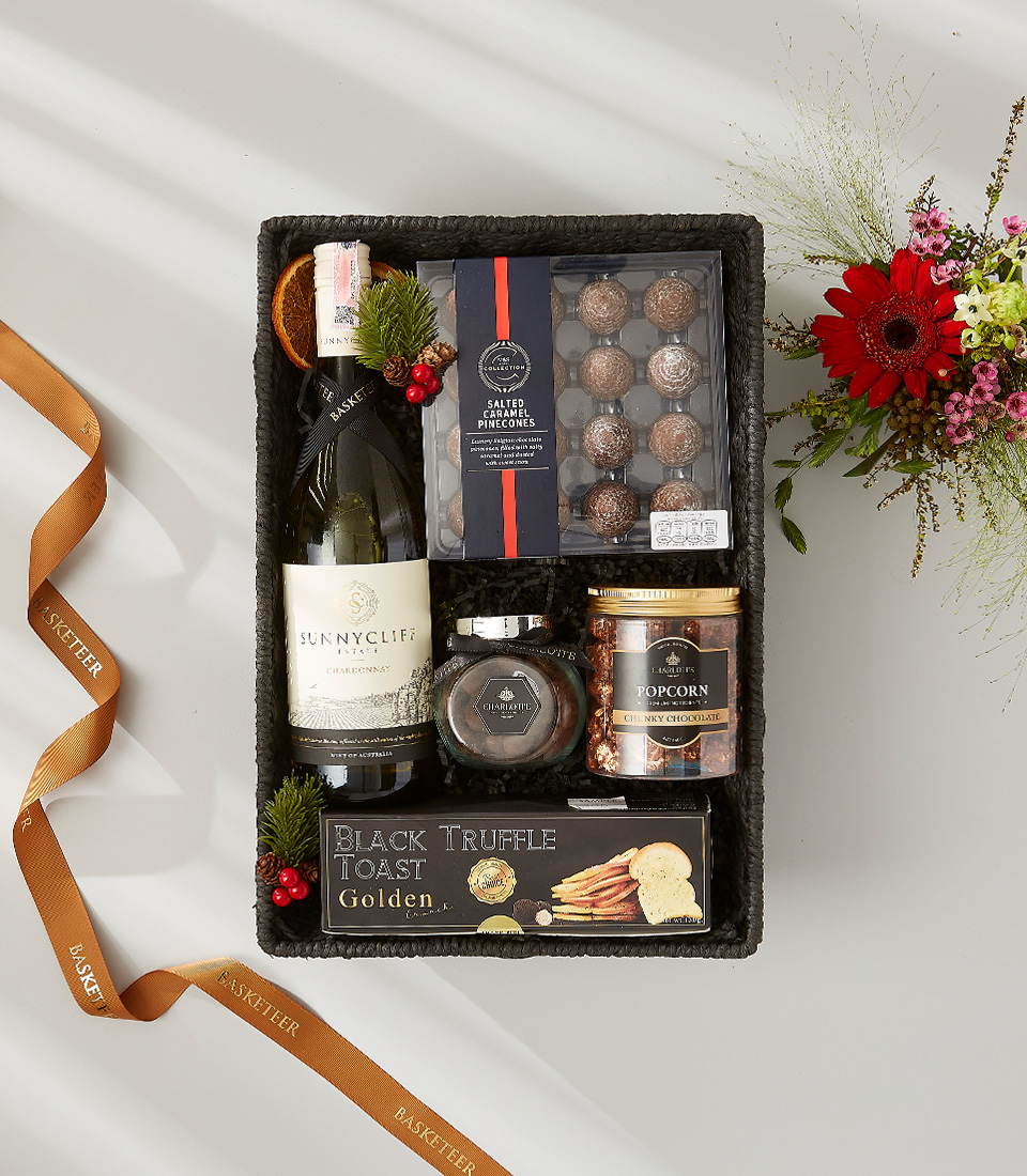 Sunny Cliff wine and gourmet gift basket with chocolates, truffle toast, and popcorn.