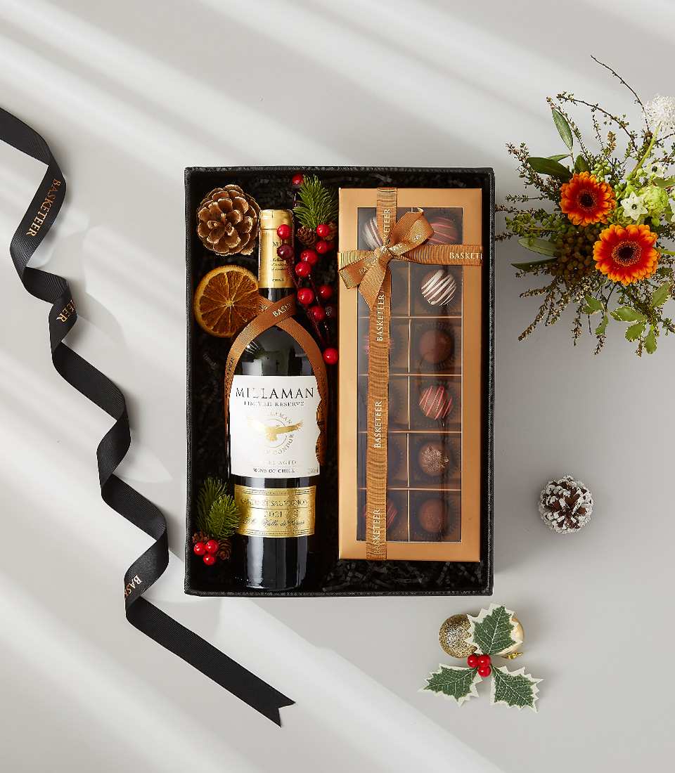 Indulge in the ultimate holiday treat with this luxurious gift basket filled with Millaman Cabernet Sauvignon, chocolates, and a touch of festive cheer.