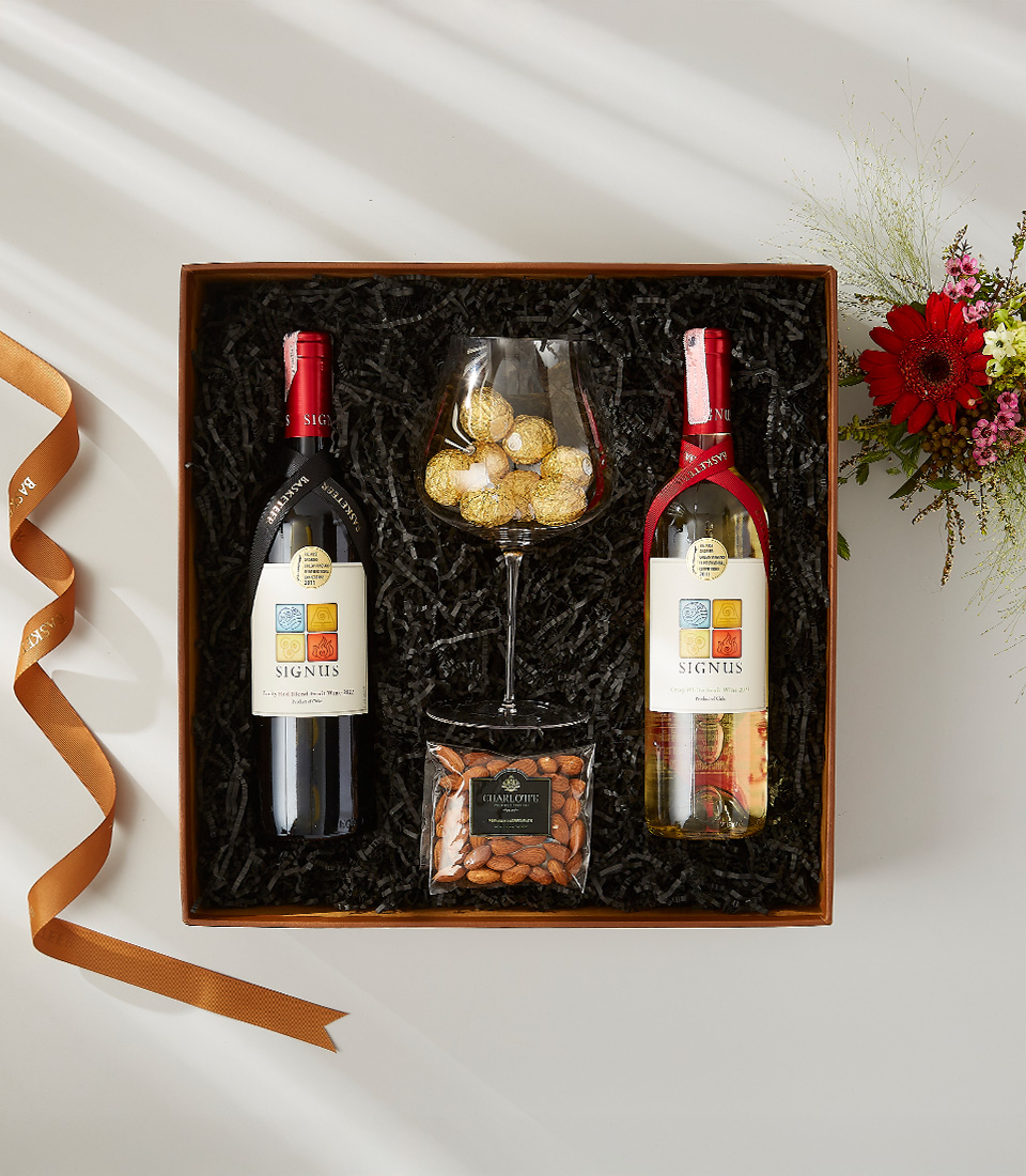 Signus red and white wine gift set with almonds, chocolate truffles, and a wine glass.