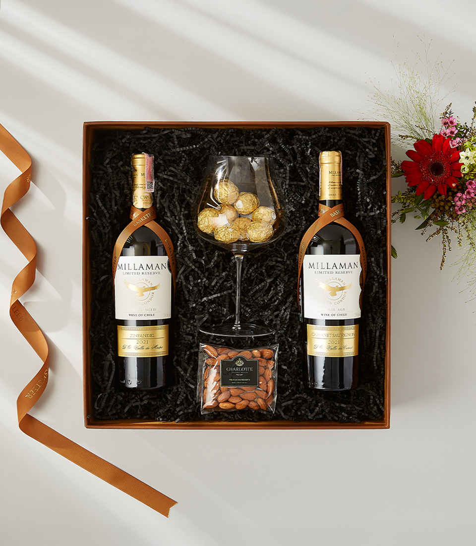 Millaman Limited Reserve red wine gift set with almonds, chocolate truffles, and a wine glass.