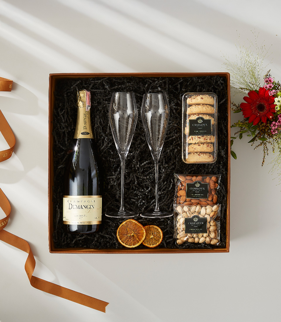 Champagne gift box with Dumangin champagne, crystal flutes, assorted nuts, and cookies.
