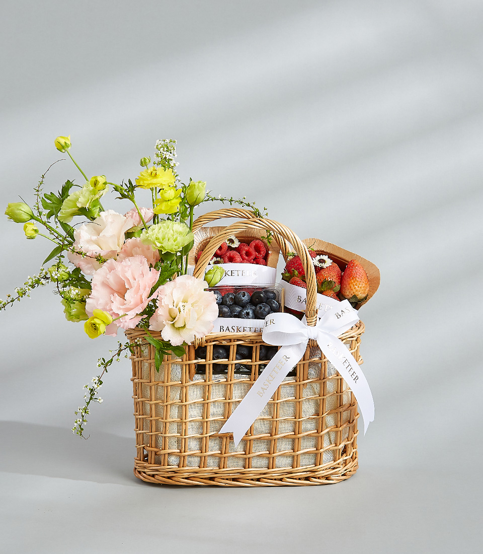 Fresh fruit and flower basket with strawberries, blueberries, raspberries, and a beautiful arrangement of pastel flowers. Title: Fresh Fruit & Flower Basket - A Delightful Gift for Special Occasions