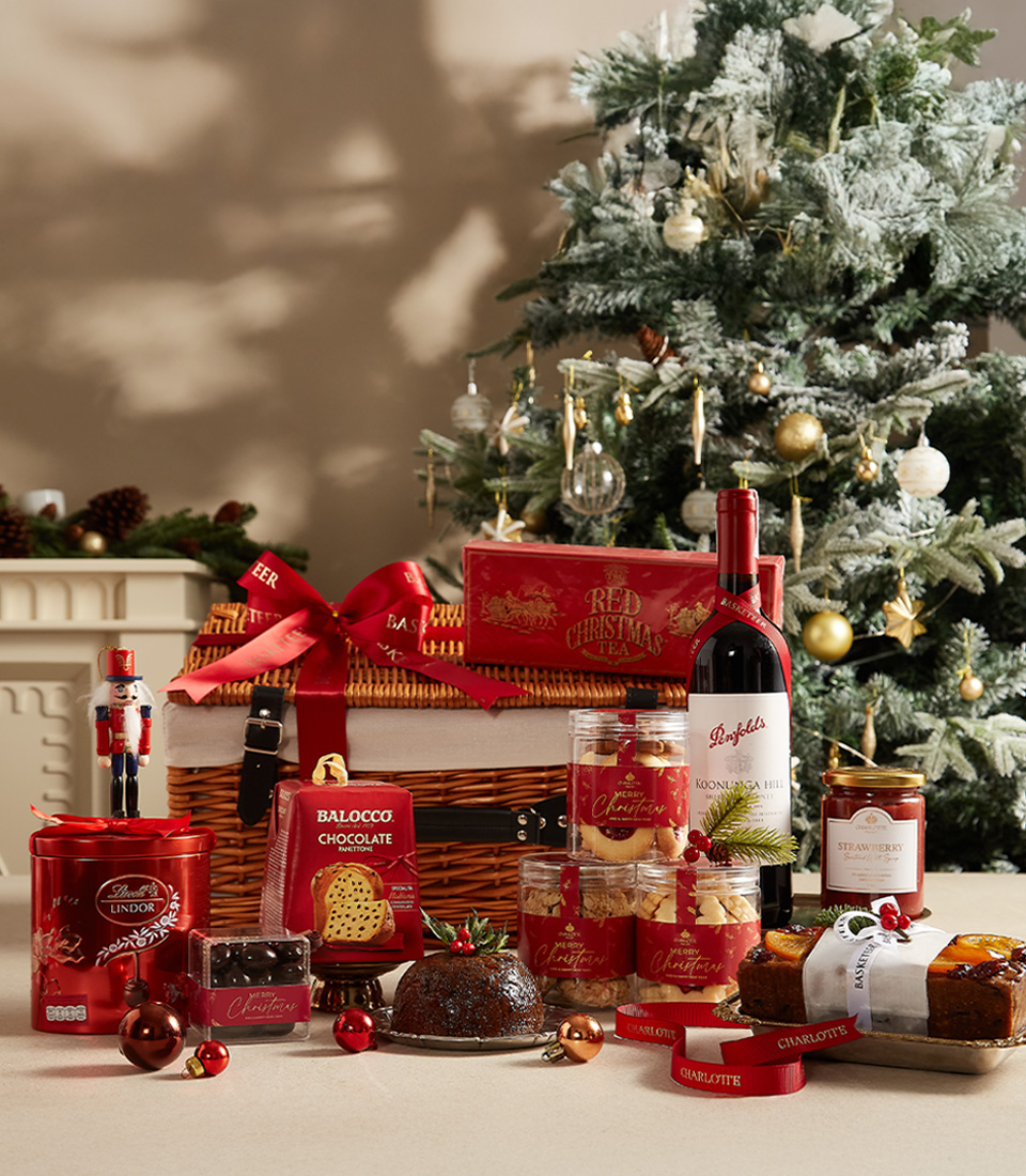 Luxurious Christmas hamper with festive treats, sweets, and tea, beautifully wrapped for the holidays.