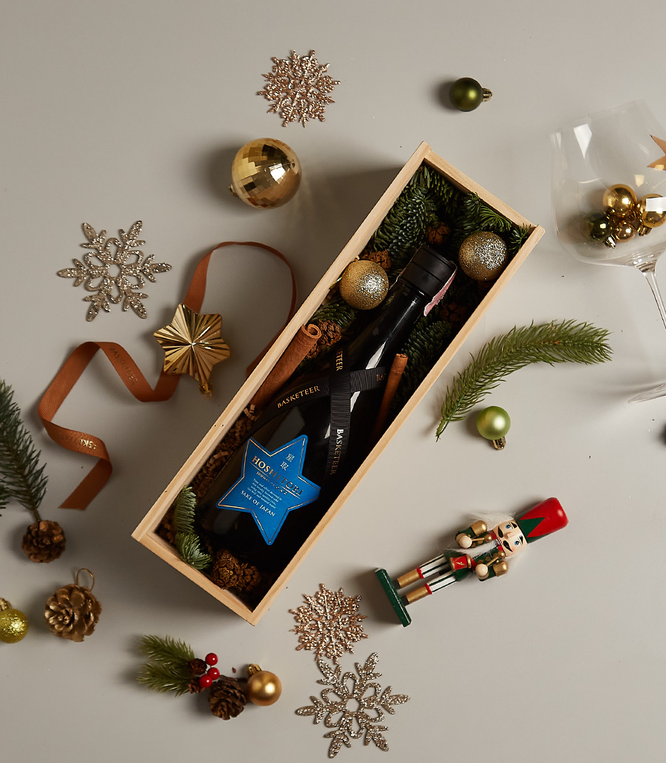 Elegant holiday gift box with premium items, festive decor, and a charming seasonal design.