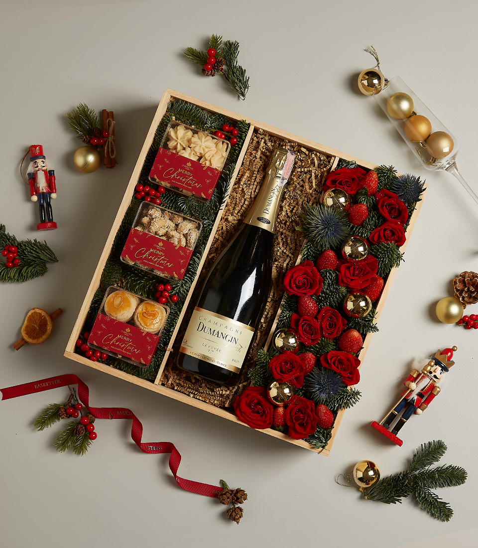 Holiday gift box with golden accents, festive treats, and luxurious decorations.