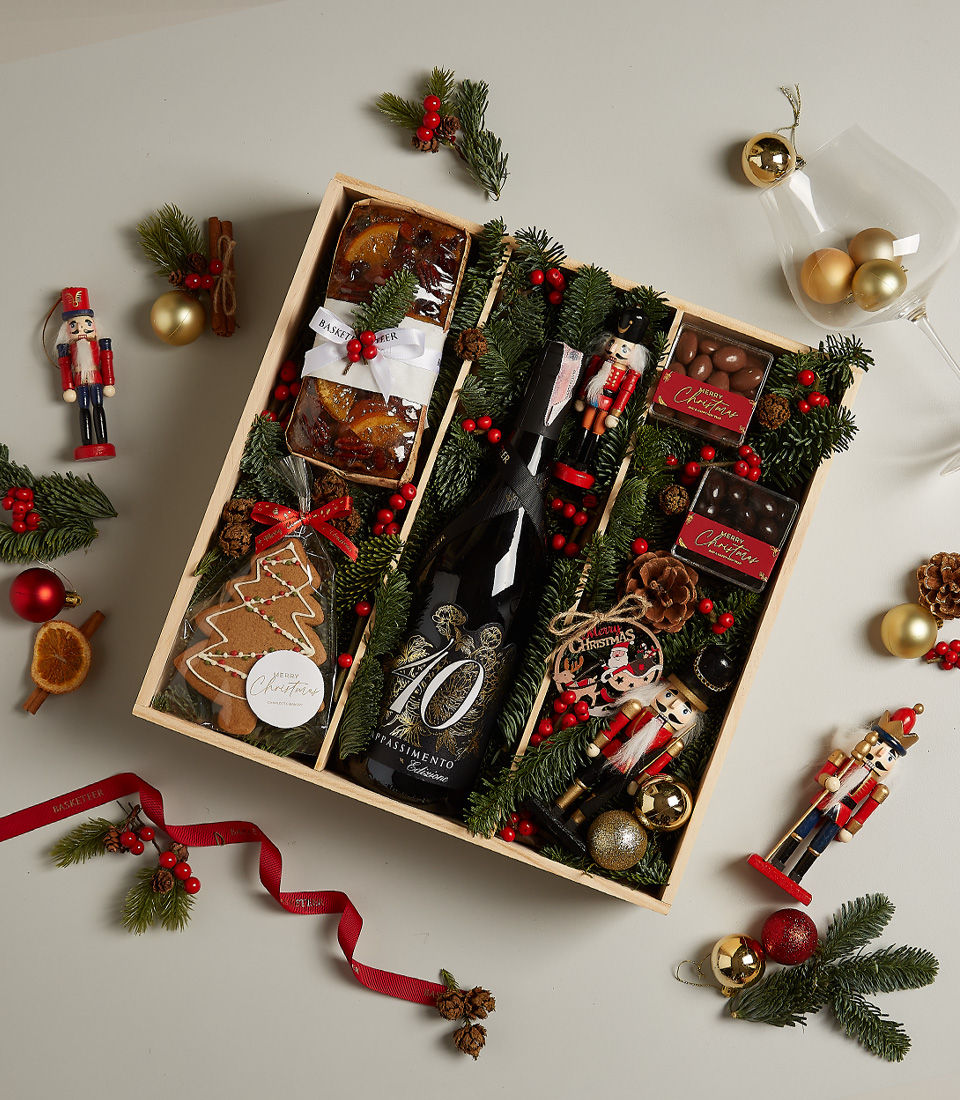 Premium holiday hamper with Amarone wine, festive fruitcake, gingerbread cookies, holiday chocolates, and seasonal décor.