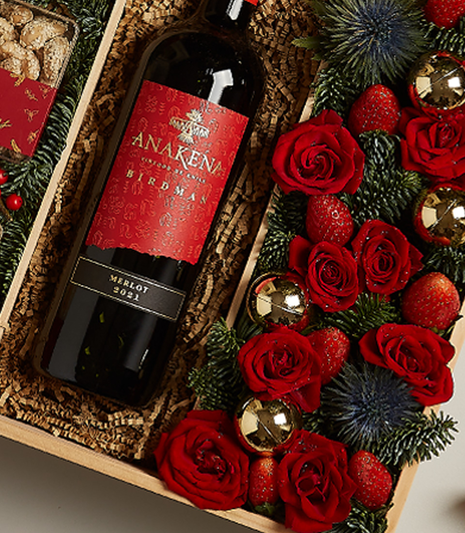 Elegant holiday gift box with red accents, festive treats, and a touch of seasonal luxury.