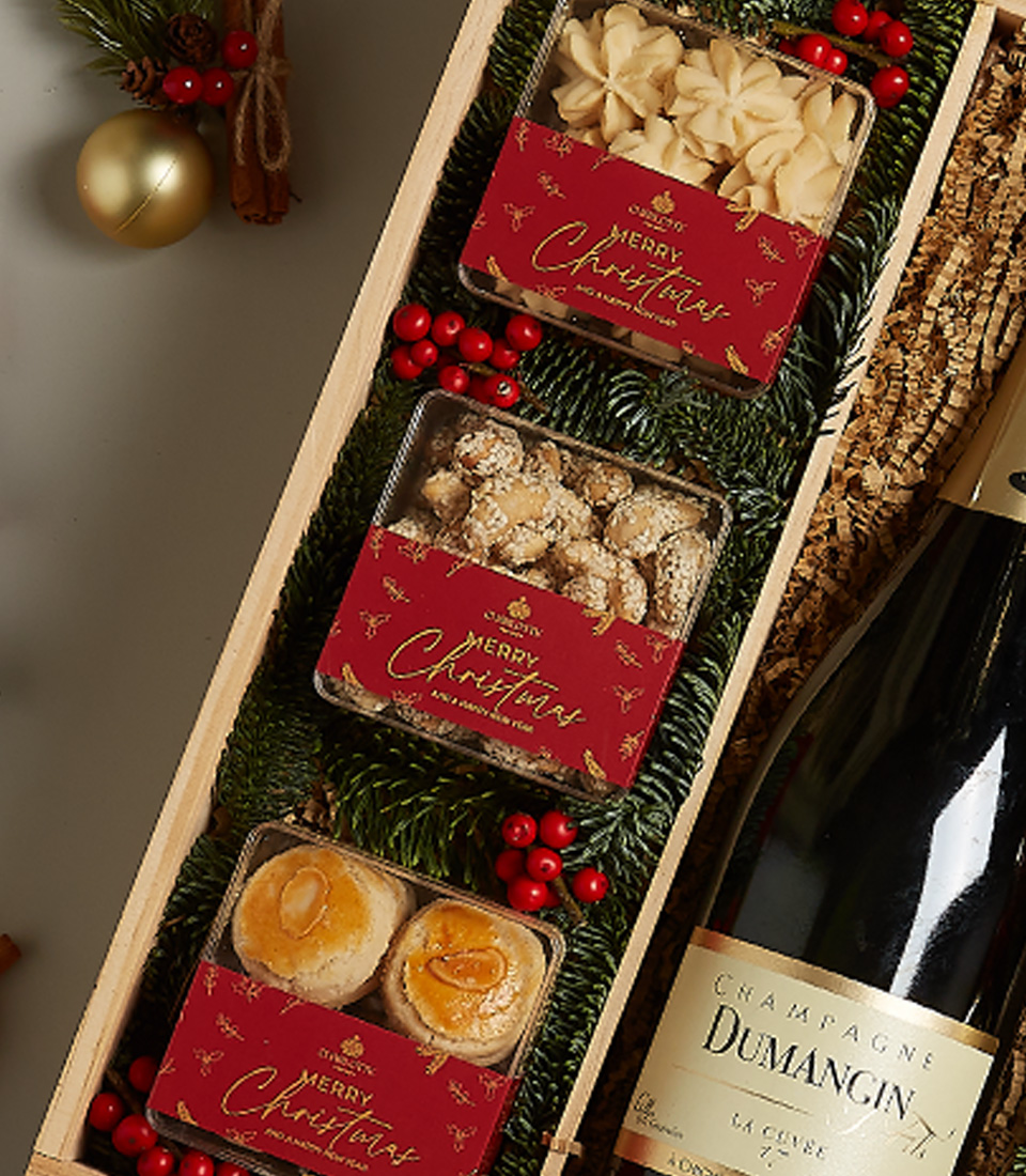 Holiday gift box with golden accents, festive treats, and luxurious decorations.