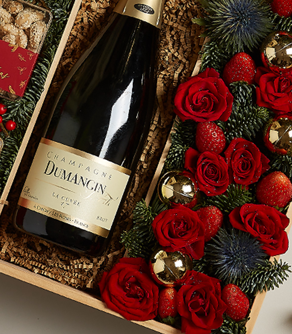 Holiday gift box with golden accents, festive treats, and luxurious decorations.