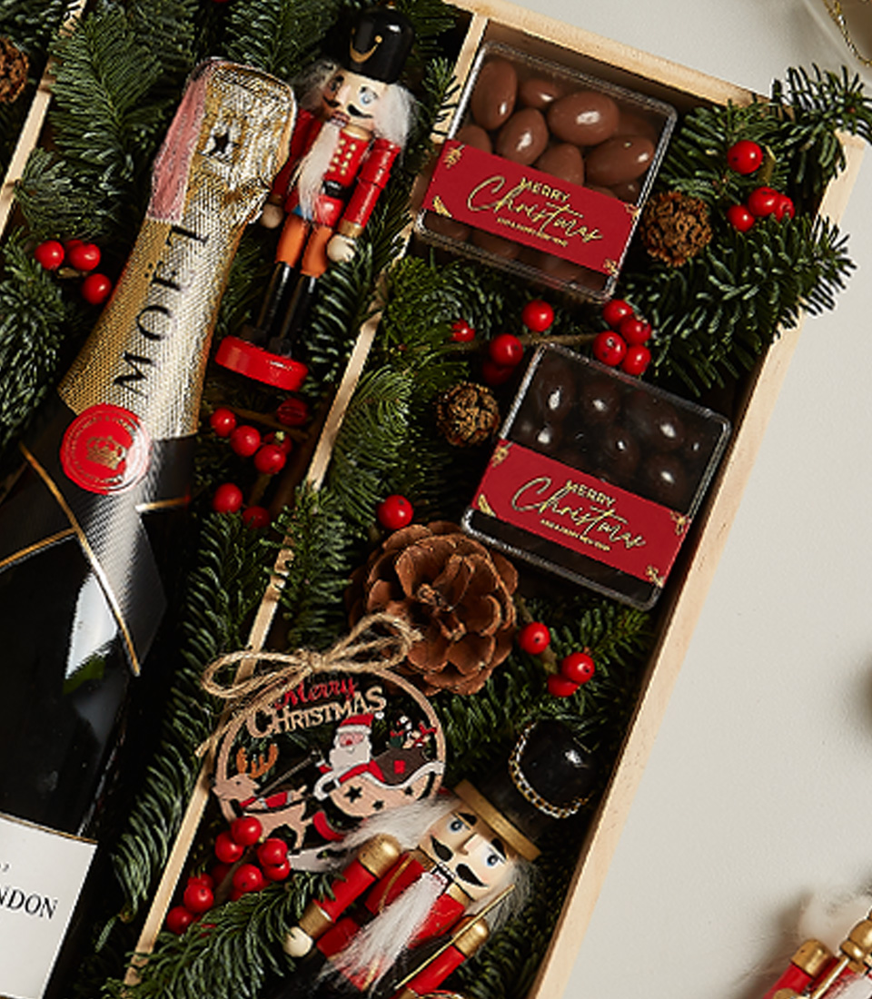 Elegant holiday gift box with chocolates, festive treats, and seasonal decorations for a memorable celebration.