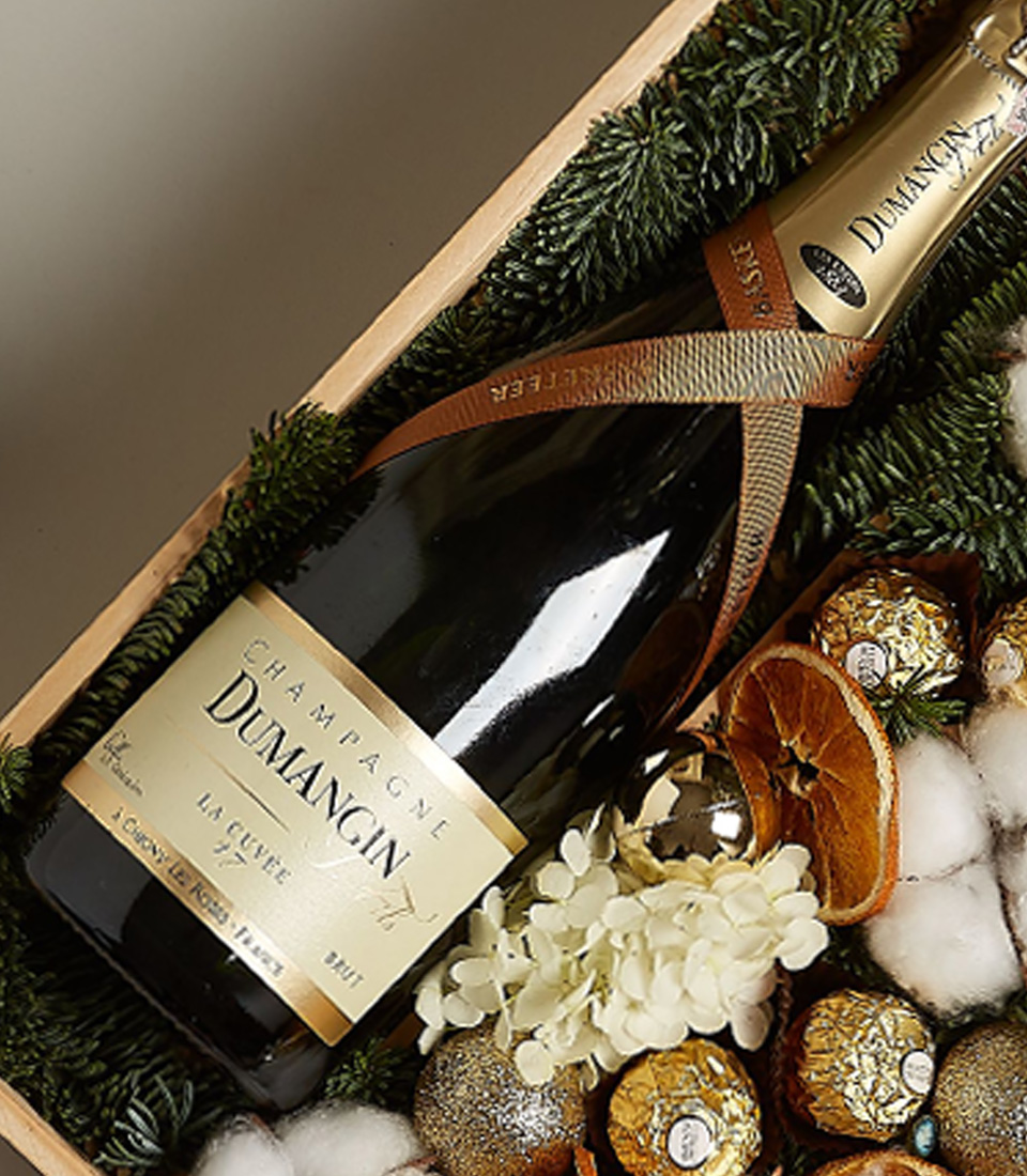 Luxury gift box with Dumangin Champagne, Ferrero Rocher chocolates, dried orange slices, cotton, hydrangeas, and festive decorations.