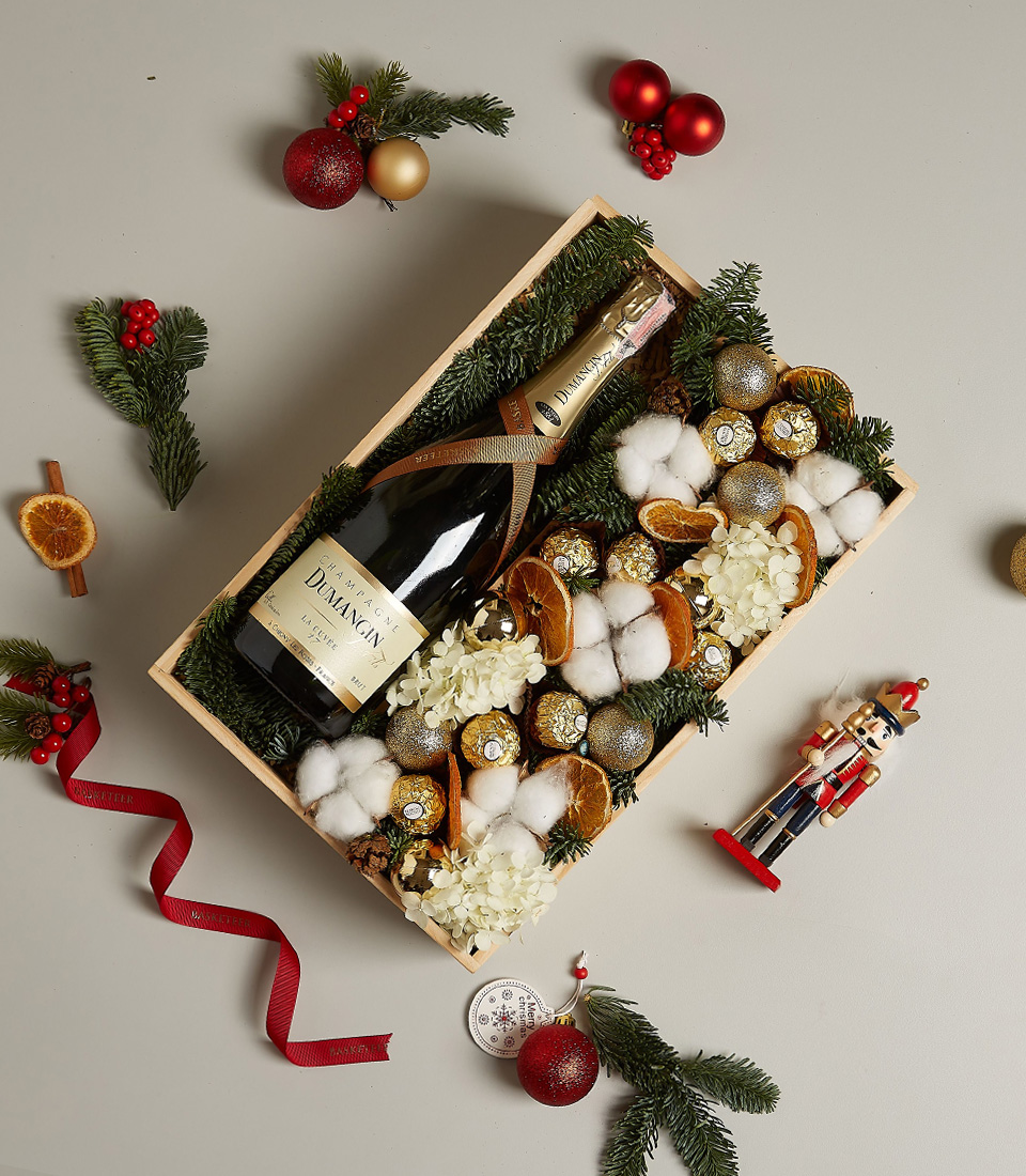Luxury gift box with Dumangin Champagne, Ferrero Rocher chocolates, dried orange slices, cotton, hydrangeas, and festive decorations.