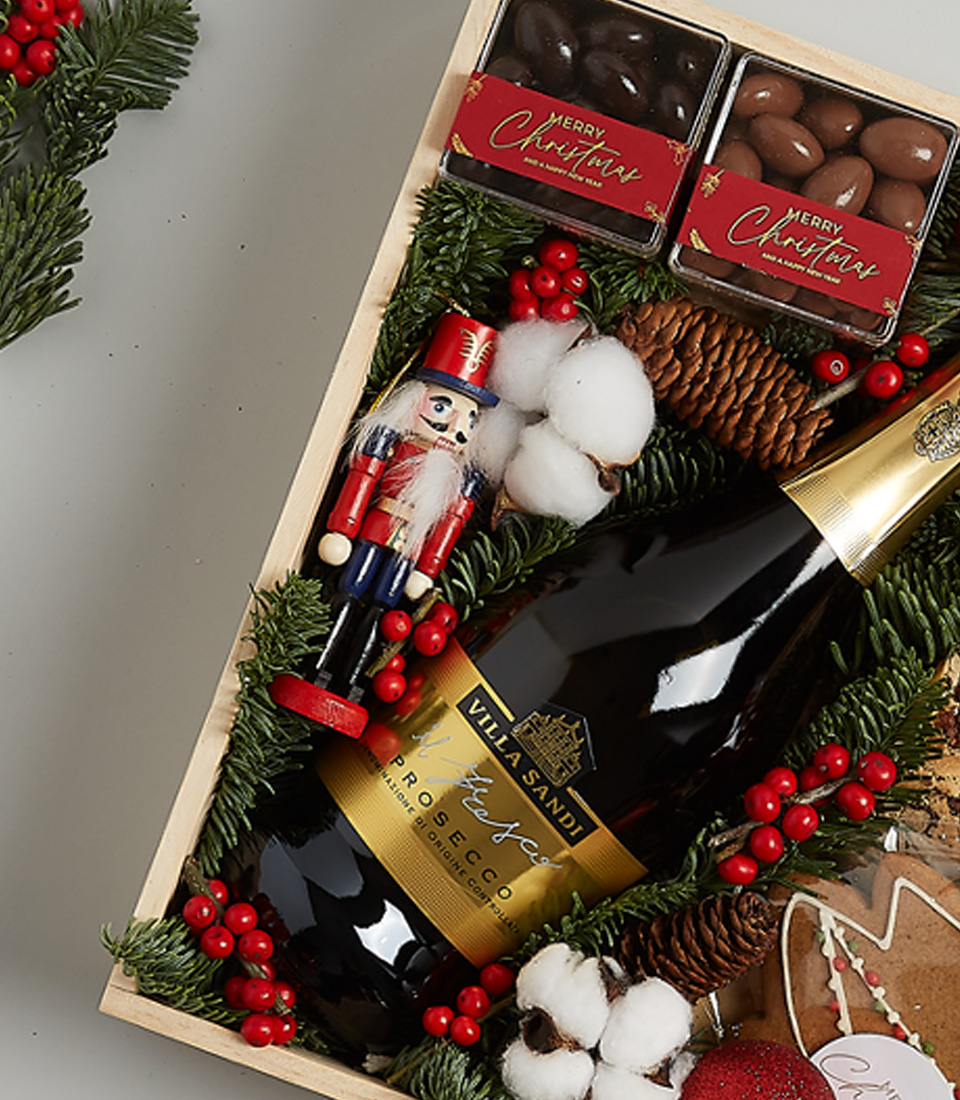 Luxury Christmas gift box with Champagne Dumangin, gingerbread cookies, chocolates, shortbread biscuits, festive greenery, and a nutcracker.