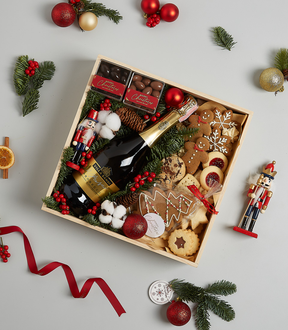 Luxury Christmas gift box with Champagne Dumangin, gingerbread cookies, chocolates, shortbread biscuits, festive greenery, and a nutcracker.